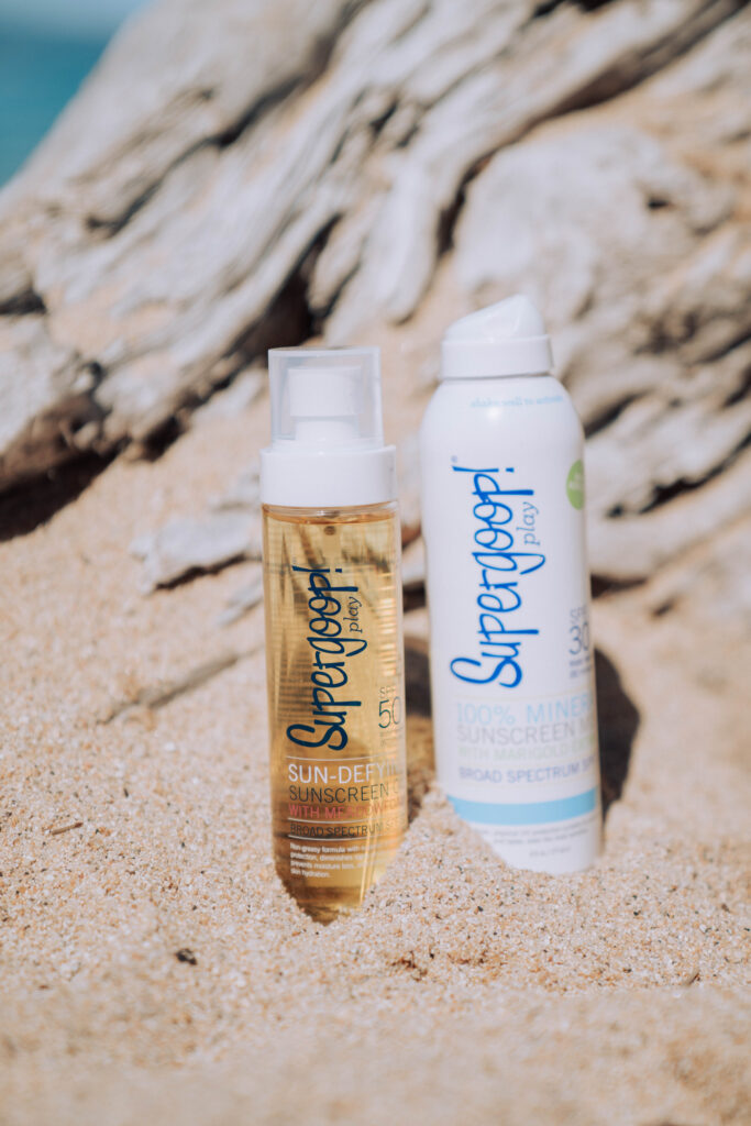 a close up of sunscreen in the sand on the beach