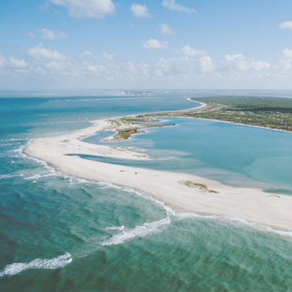 aerial image of the ocean and a sand bar with call to action text of get the points and miles crash course